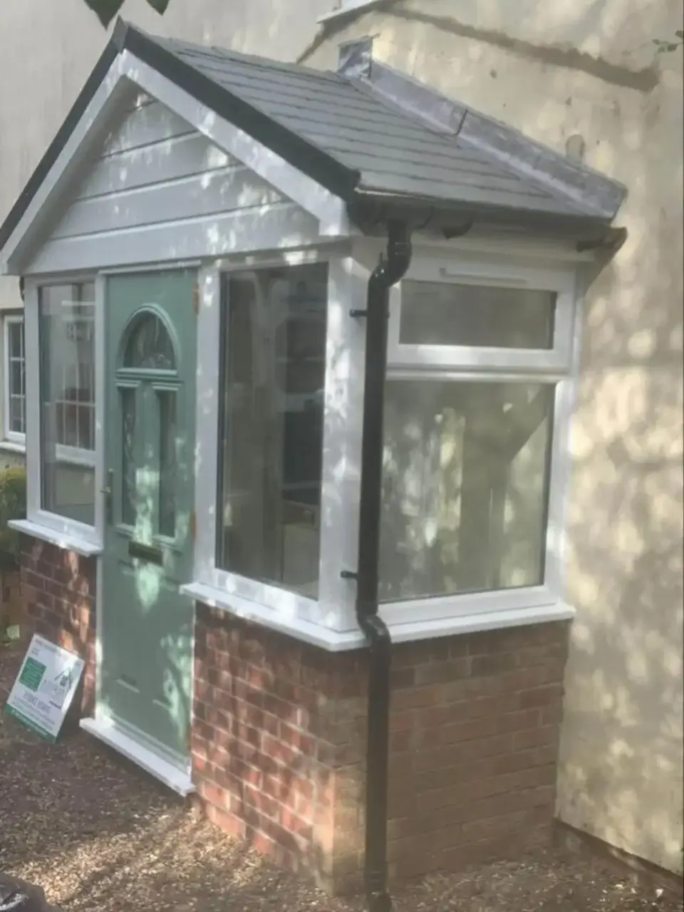 Modern composite front door installation with secure glazing panels on a residential property in Norfolk. Crafted by Norfolk Exterior Solutions